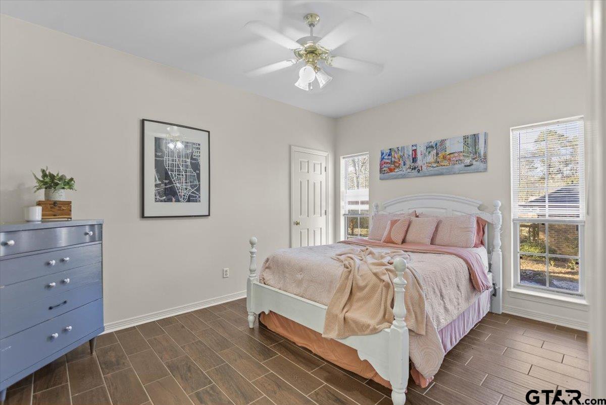 1336 Bridle Path Lane Hideaway, TX 75771 - Photo 6 of 48 a bedroom with a bed and a chandelier