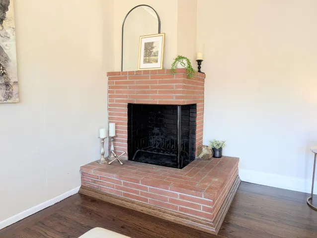 a room with a fireplace and wooden floor