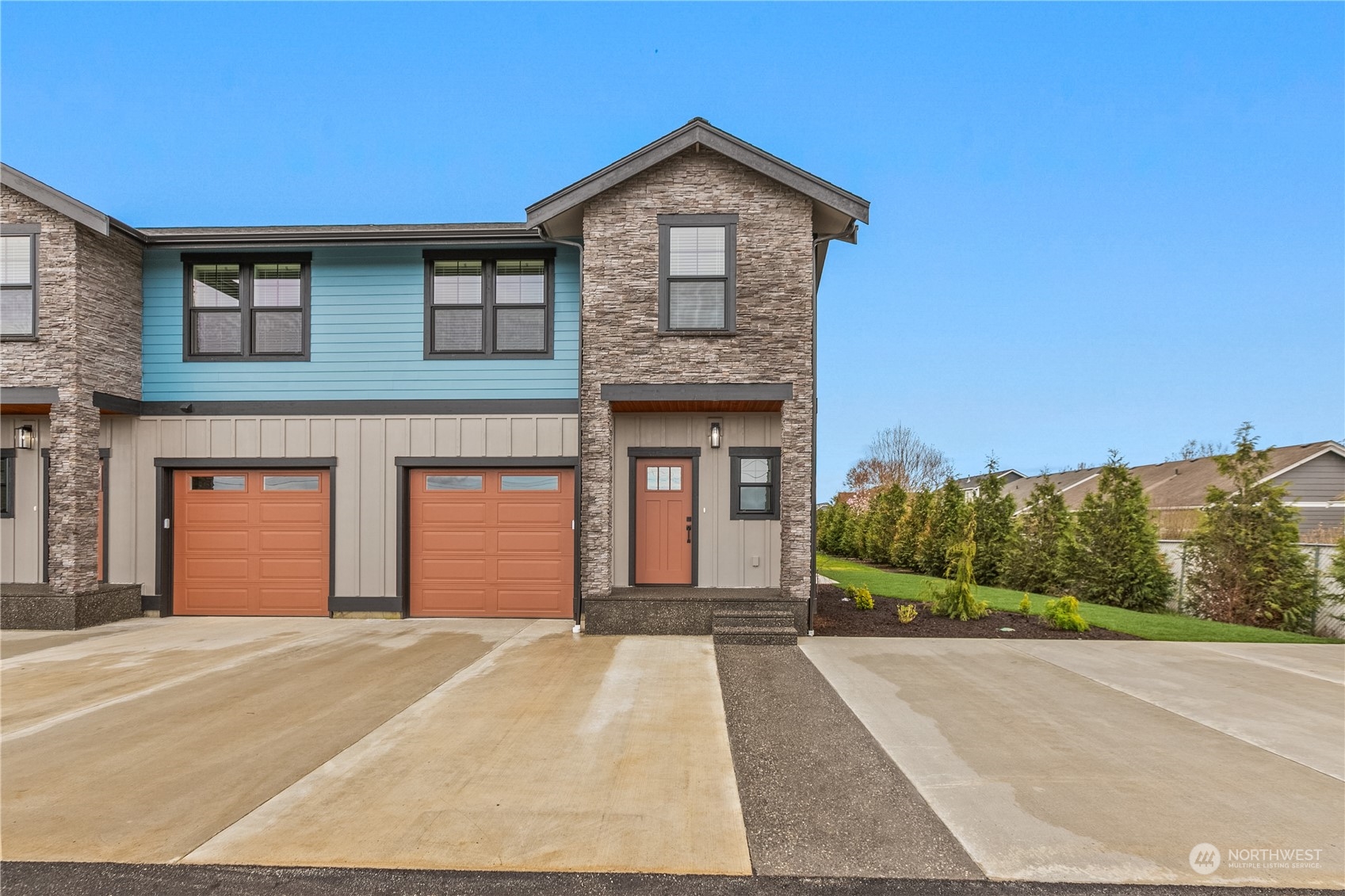 2217 Dejong Drive Lynden, WA 98264 - Photo 7 of 28 a front view of a house with a yard and garage