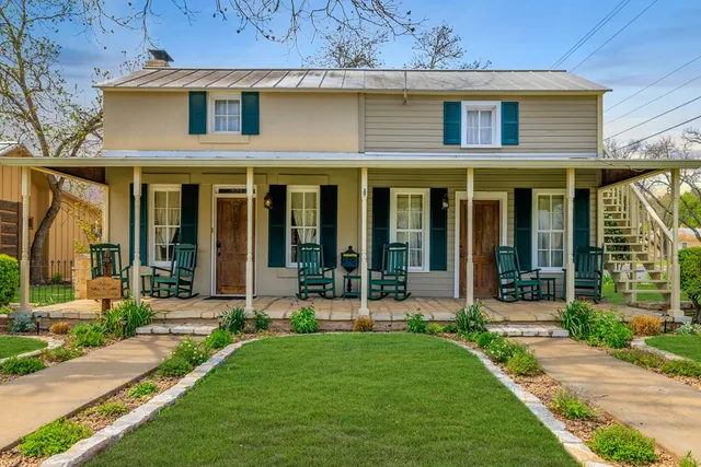 a view of a chair and table in the back yard of the house