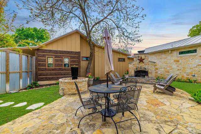 a kitchen with stainless steel appliances a stove a chandelier and wooden floor