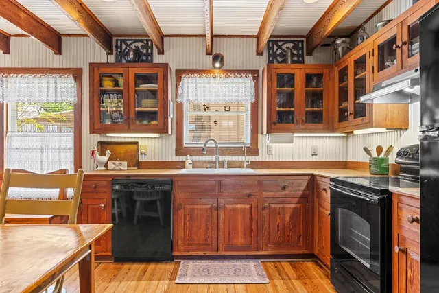 a spacious bedroom with a bed and wooden floor