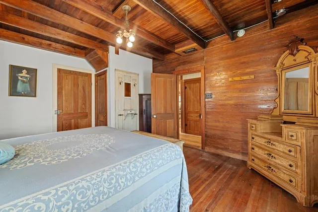 a bedroom with a bed and a dresser