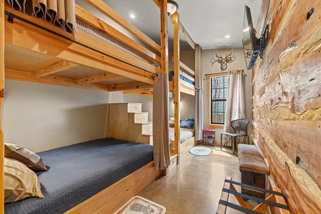 a front view of a house with garden and trees