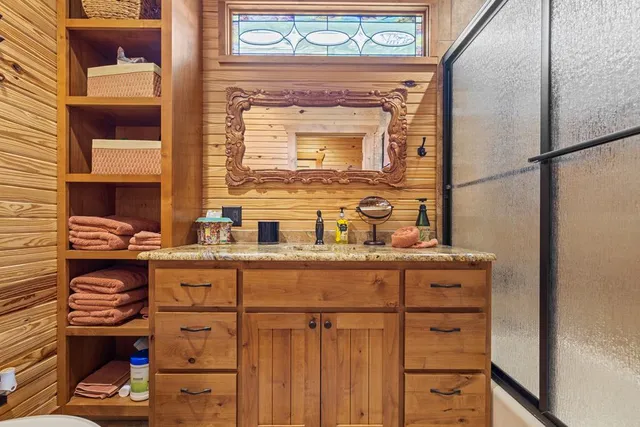 a view of a chair and table in backyard of the house