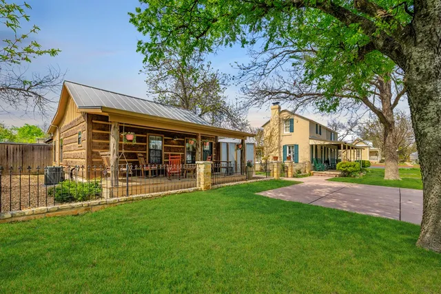a view of a patio with table and chairs and potted plants