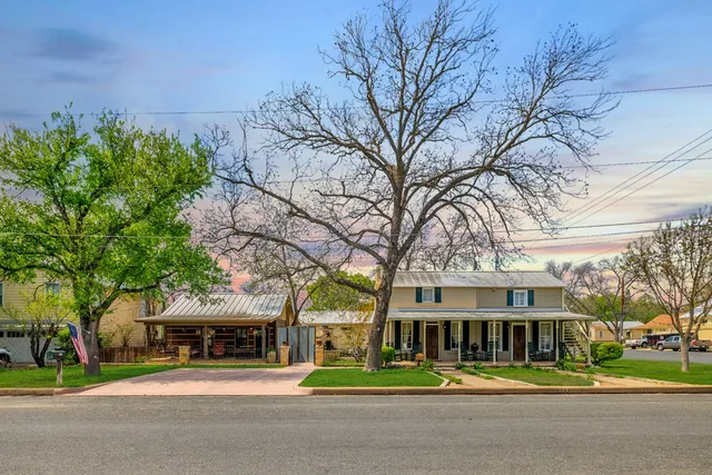 a view of house with backyard and furniture