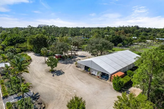 an aerial view of a house with a yard and sitting area
