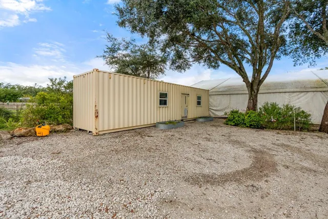 a backyard of a house with plants and outdoor seating