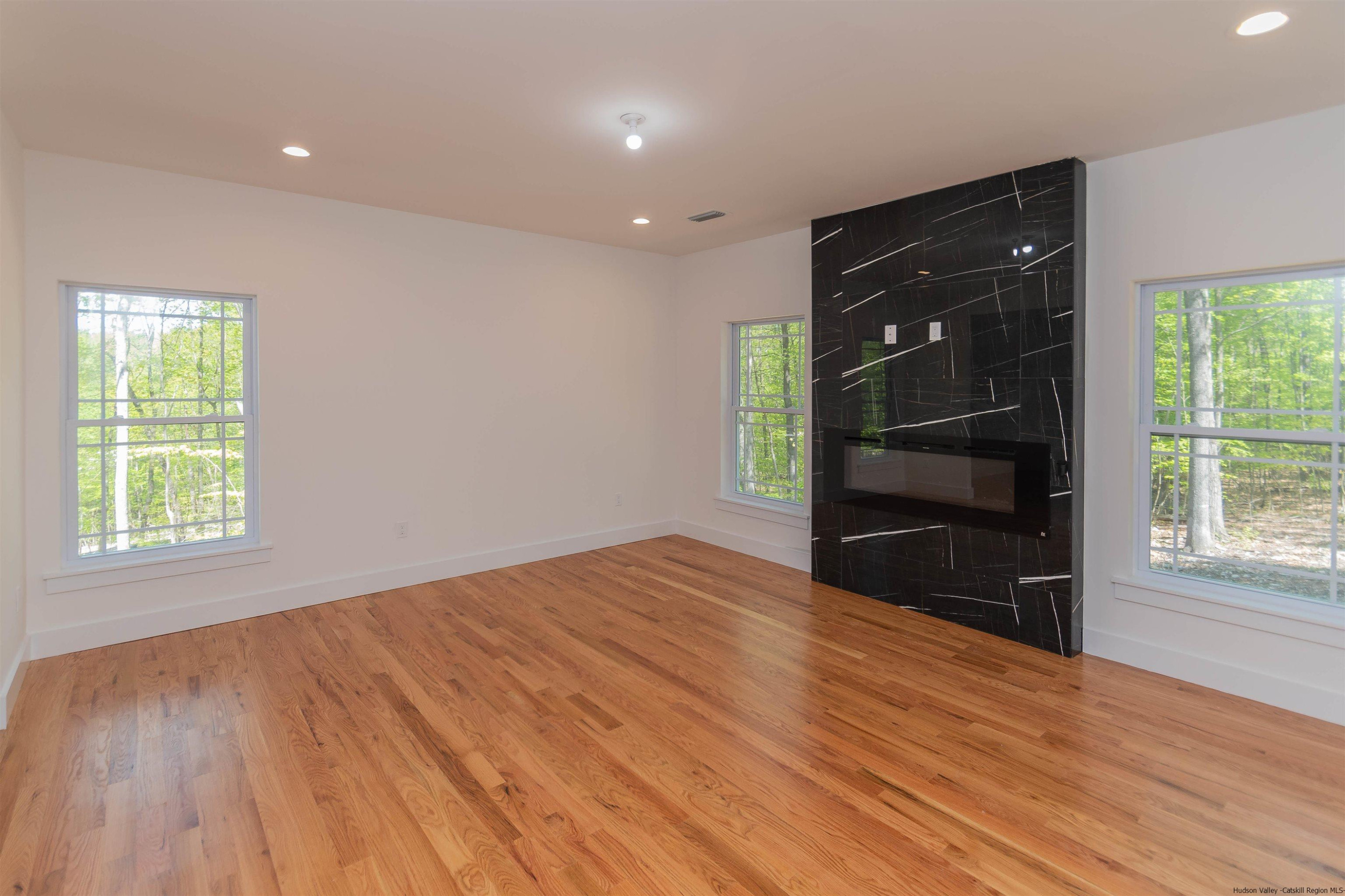 5 Calico Ways Ways, Unit WAYS Wallkill, NY 12589 - Photo 15 of 35 a view of empty room with wooden floor and fan