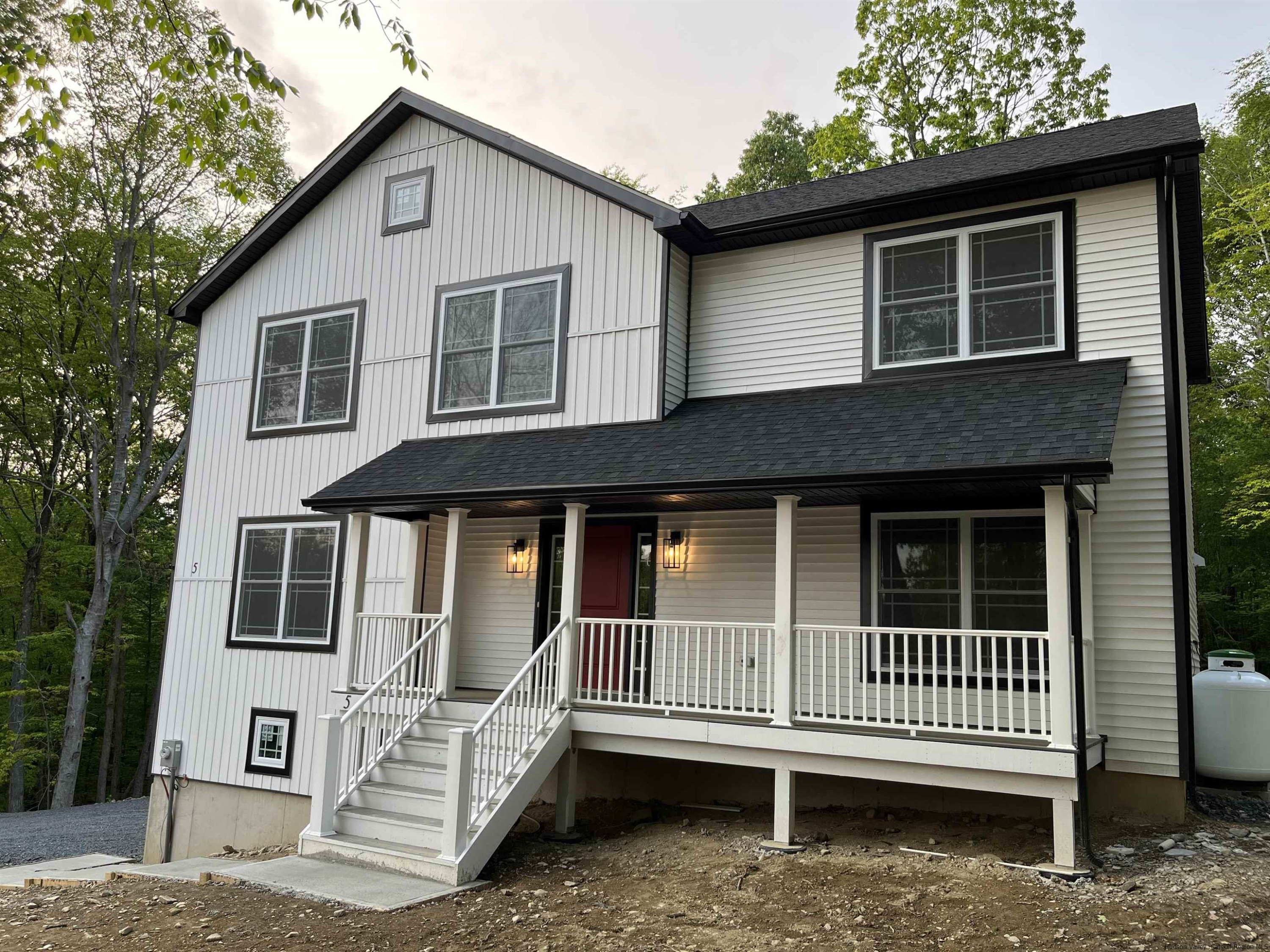 5 Calico Ways Ways, Unit WAYS Wallkill, NY 12589 - Photo 2 of 35 a porch with a bench next to a yard