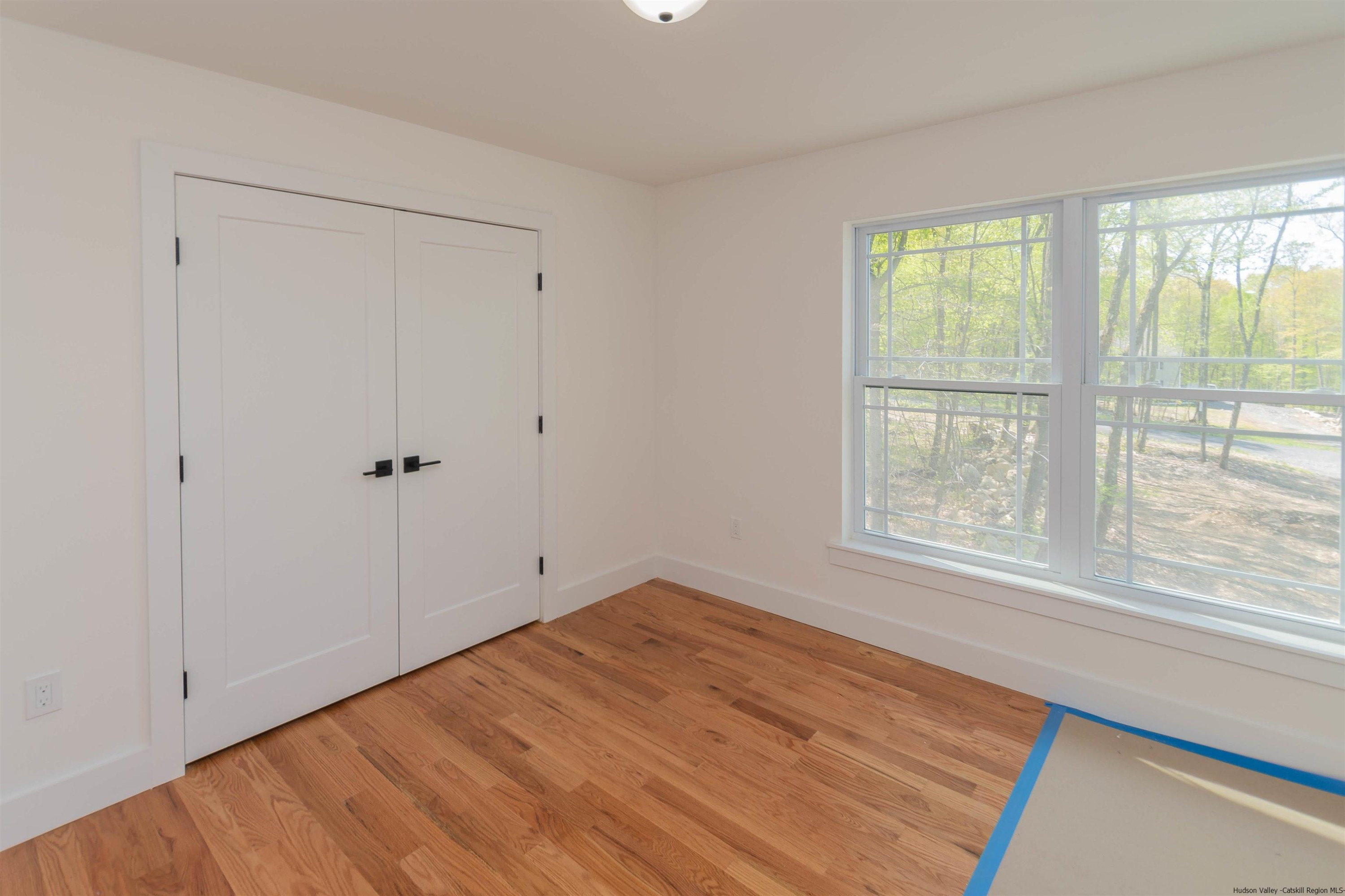 5 Calico Ways Ways, Unit WAYS Wallkill, NY 12589 - Photo 28 of 35 a view of empty room with wooden floor and fan
