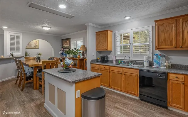 a kitchen with sink a stove and chairs