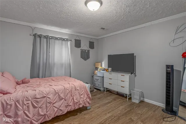 a bedroom with a bed and flat screen tv