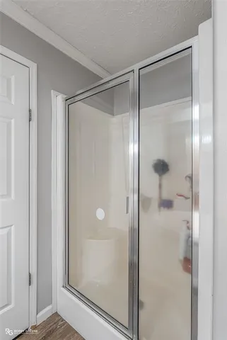 a bathroom with a glass shower door