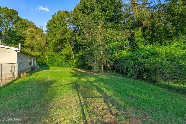 a house with green field in front of it
