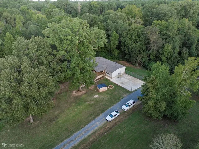 an aerial view of a house with yard