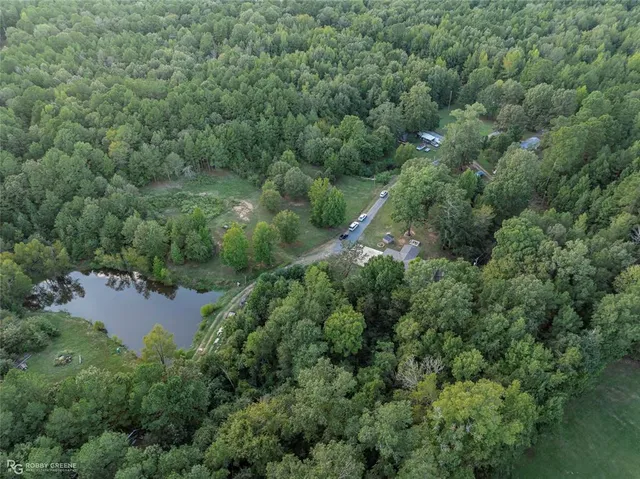 an aerial view of a house with a yard