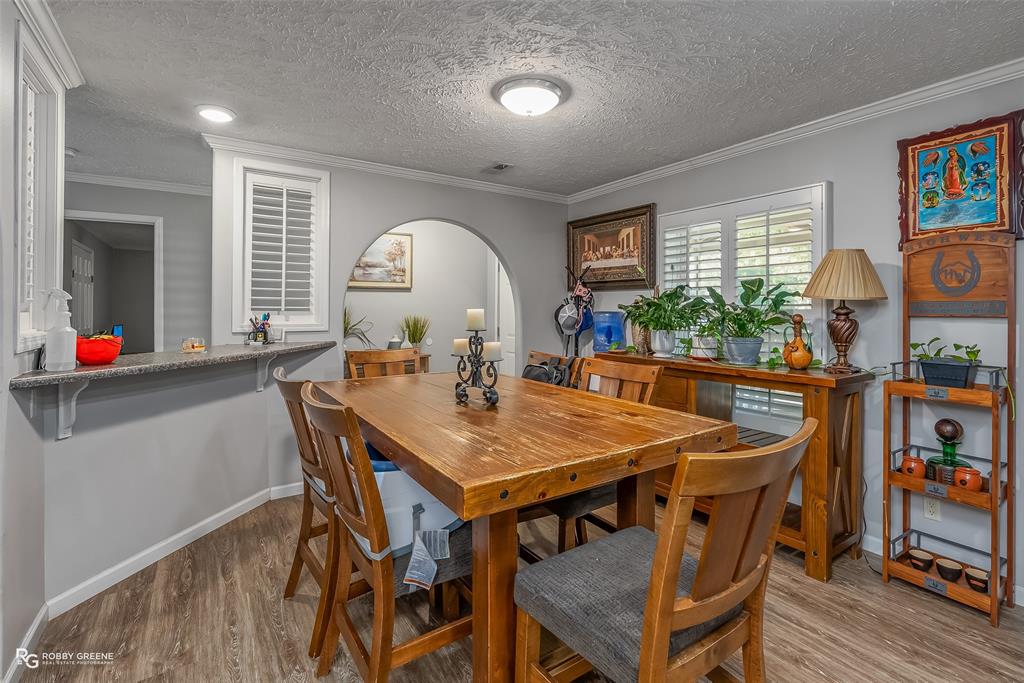 8287 Jefferson Paige Road Shreveport, LA 71119 - Photo 9 of 40 Dining space with wood finished floors, ornamental molding, a textured ceiling, and arched walkways