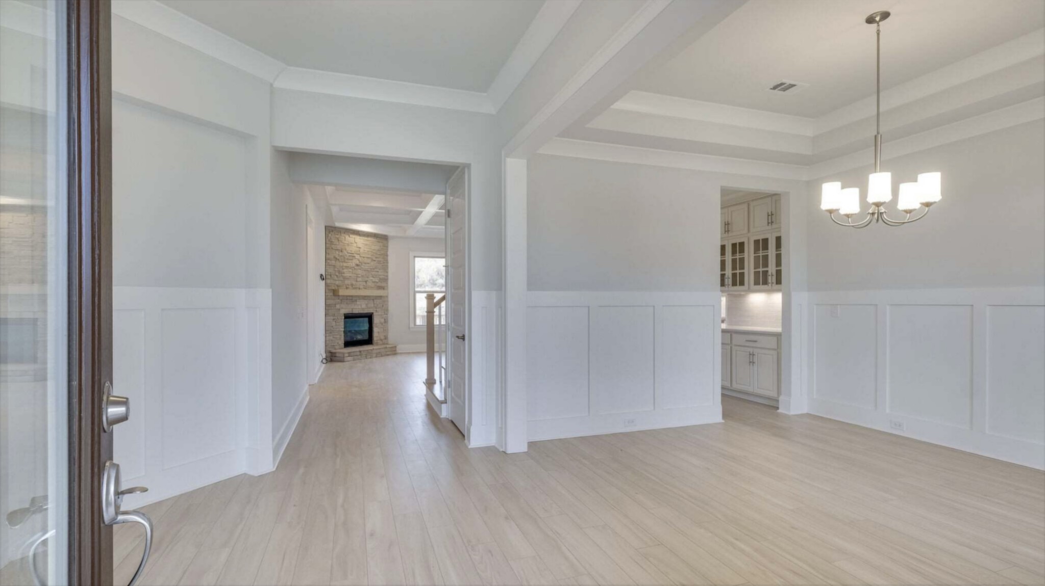 3203 Chase Point Drive Franklin, TN 37067 - Photo 4 of 30 a view of a hallway with wooden floor and a chandelier