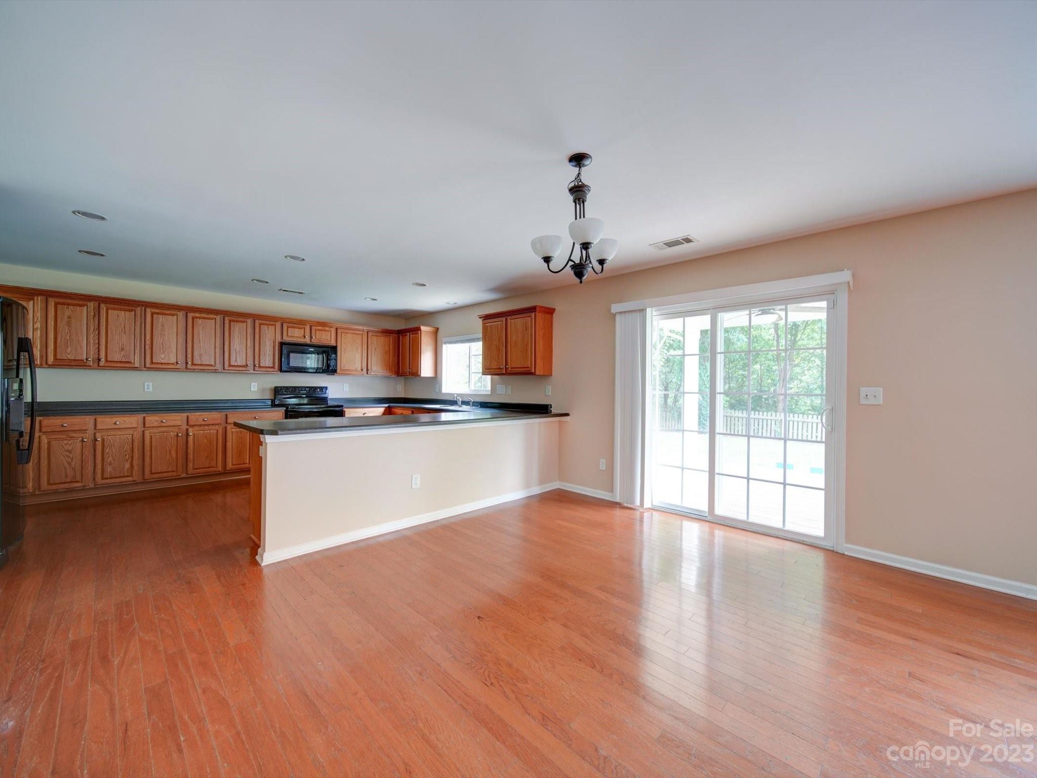 9221 Seamill Road Charlotte, NC 28278 - Photo 11 of 38 a view of kitchen with furniture and wooden floor