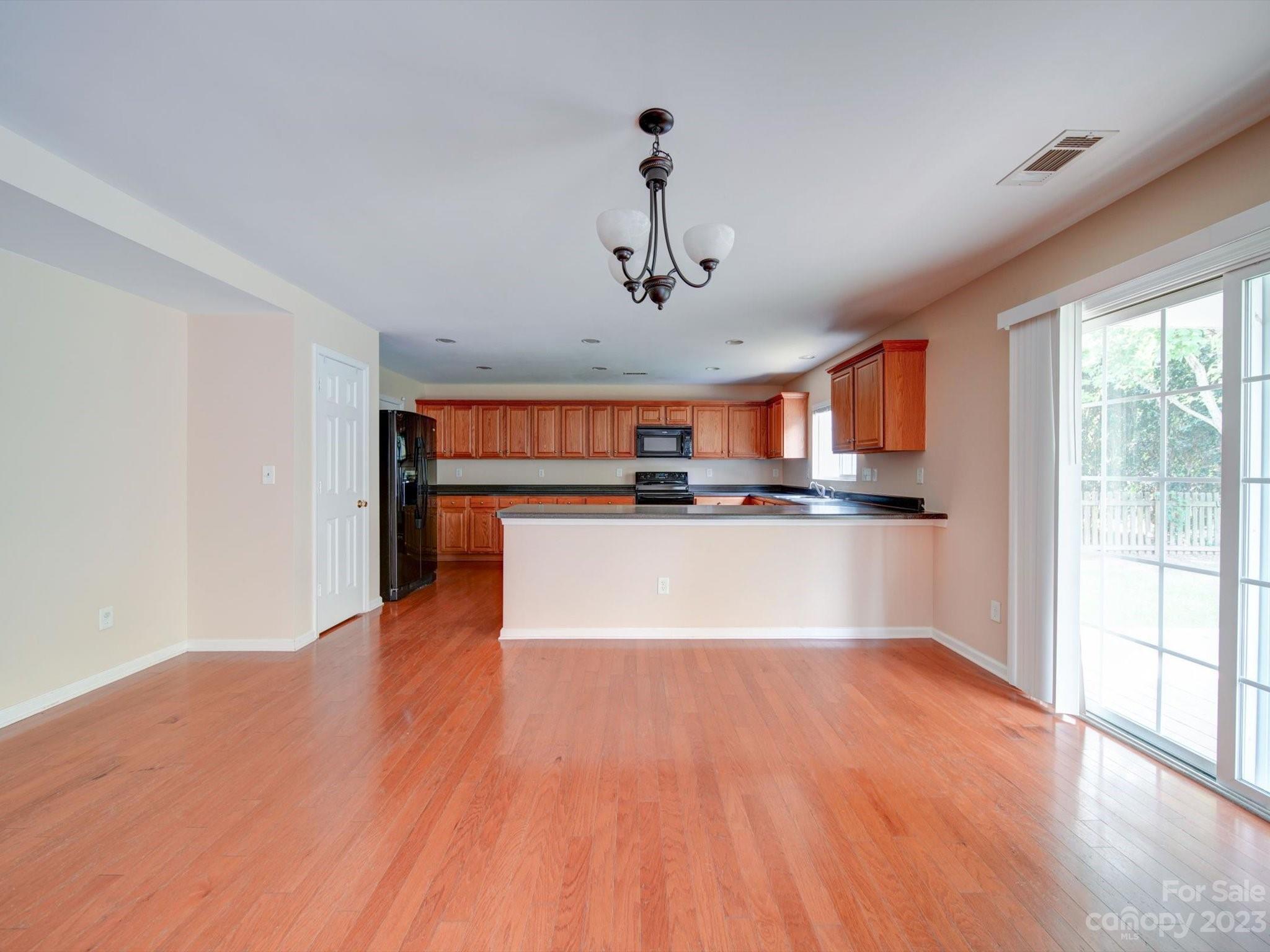 9221 Seamill Road Charlotte, NC 28278 - Photo 12 of 38 a view of kitchen with stainless steel appliances granite countertop a stove top oven and a refrigerator