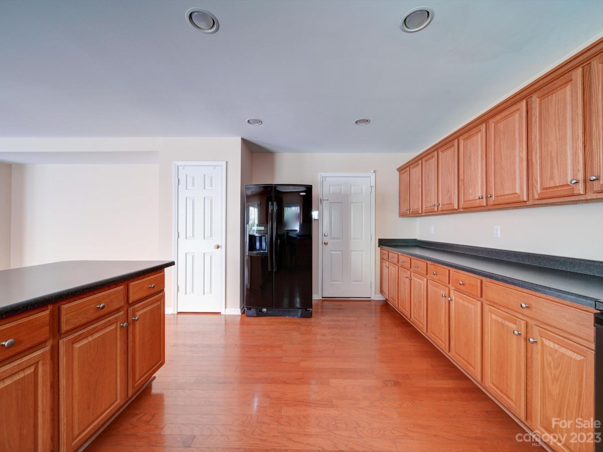 9221 Seamill Road Charlotte, NC 28278 - Photo 14 of 38 a large kitchen with stainless steel appliances granite countertop a refrigerator and a sink