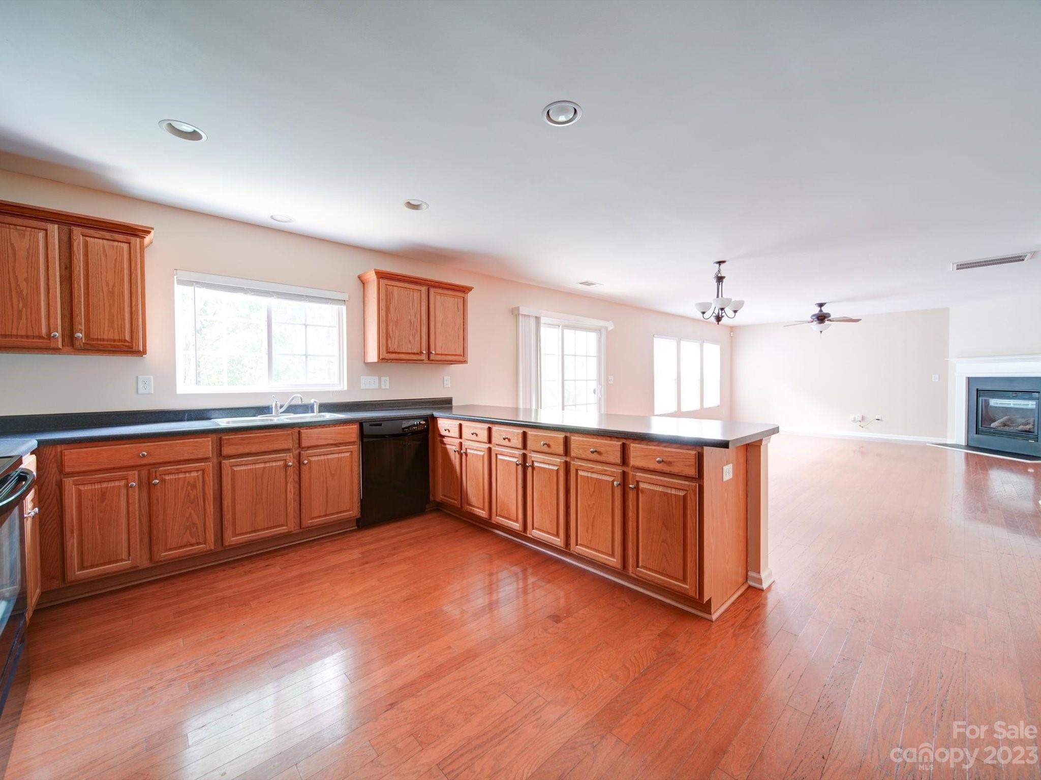 9221 Seamill Road Charlotte, NC 28278 - Photo 16 of 38 a large kitchen with stainless steel appliances granite countertop a large counter top a sink and a dishwasher