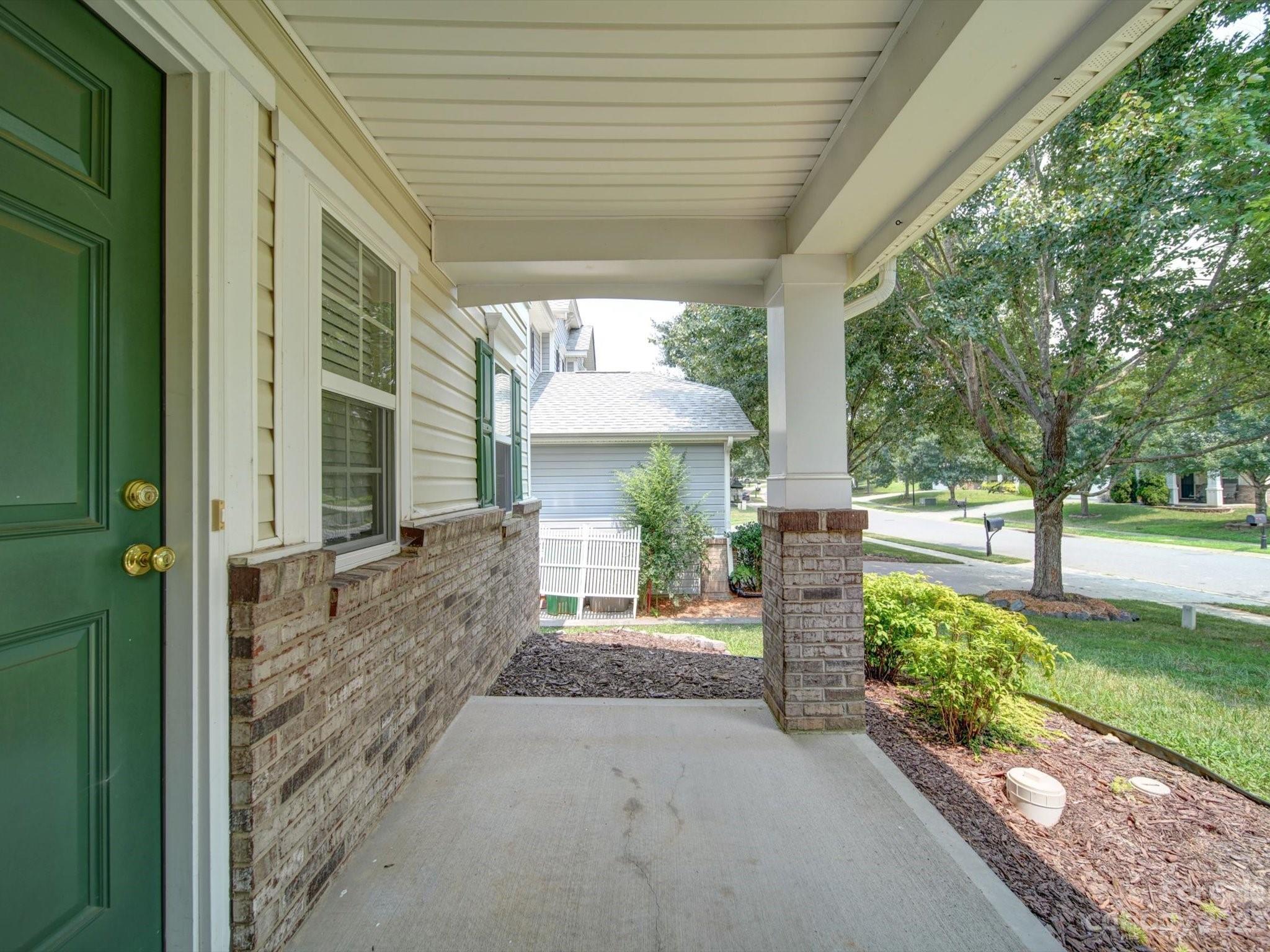 9221 Seamill Road Charlotte, NC 28278 - Photo 2 of 38 a porch with a table and chairs in patio