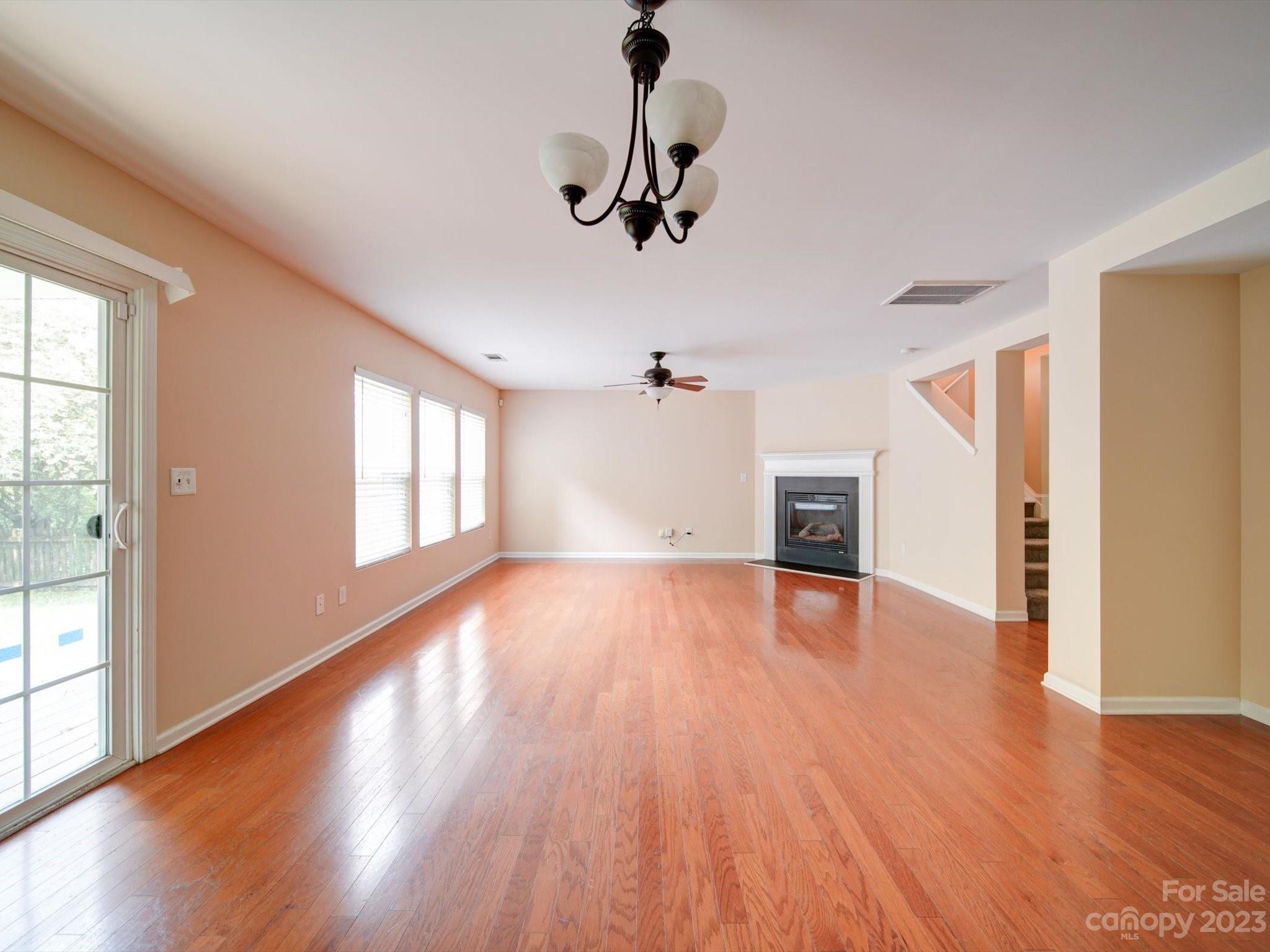 9221 Seamill Road Charlotte, NC 28278 - Photo 8 of 38 a view of empty room with wooden floor and fan