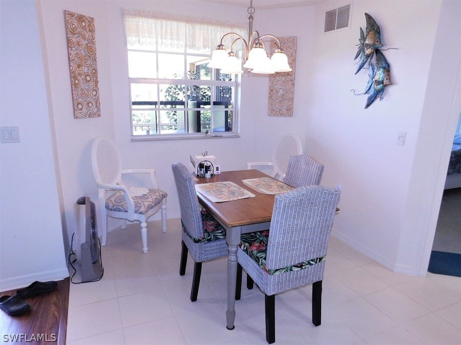 5180 Park Road, Unit 1 Fort Myers, FL 33908 - Photo 12 of 24 a view of a dining room with furniture and chandelier