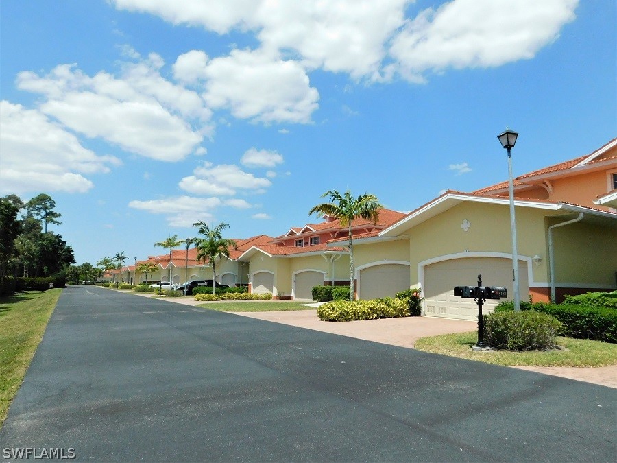 5180 Park Road, Unit 1 Fort Myers, FL 33908 - Photo 2 of 24 a front view of a house with a yard and garage
