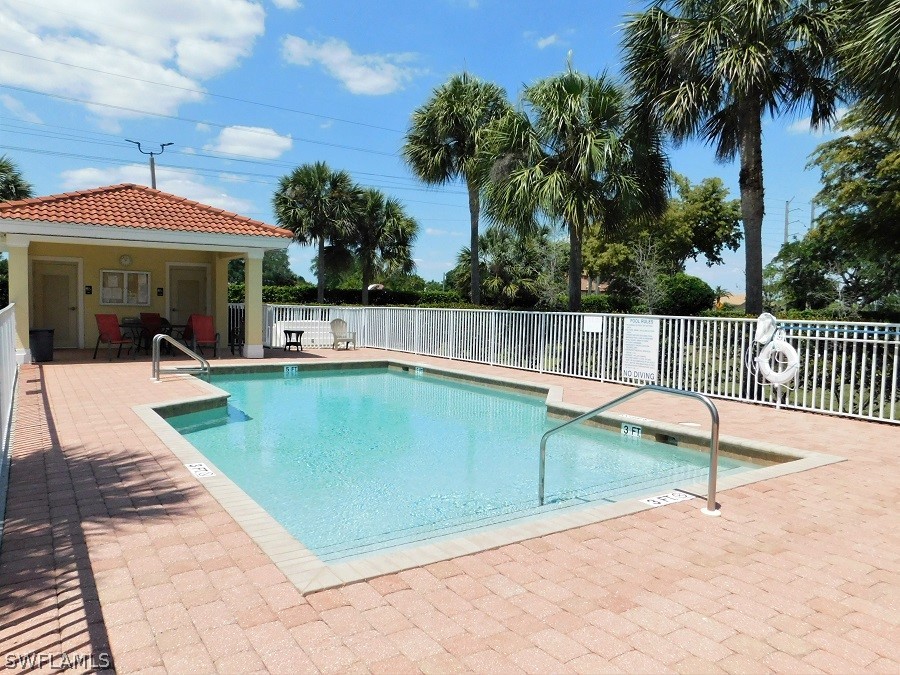 5180 Park Road, Unit 1 Fort Myers, FL 33908 - Photo 4 of 24 a view of a patio with a table and chairs under an umbrella