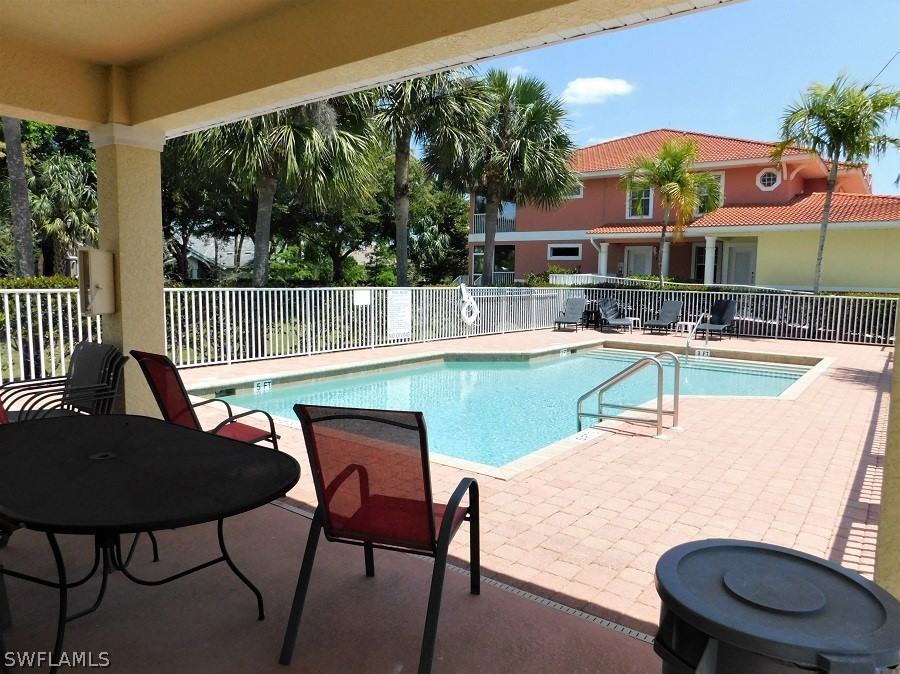 5180 Park Road, Unit 1 Fort Myers, FL 33908 - Photo 5 of 24 a balcony with table and chairs