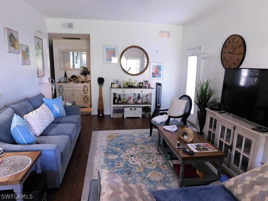 5180 Park Road, Unit 1 Fort Myers, FL 33908 - Photo 9 of 24 a living room with furniture a rug potted plant and a mirror