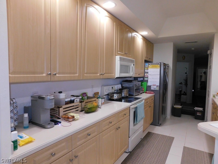 5180 Park Road, Unit 1 Fort Myers, FL 33908 - Photo 10 of 24 a kitchen with stainless steel appliances granite countertop a sink a stove a refrigerator and cabinets