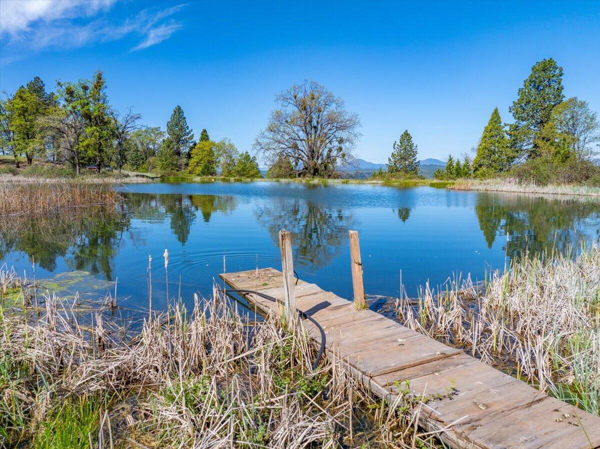 16483 Buzzard Roost Road Bella Vista, CA 96008 - Photo 15 of 138 a view of a lake with a house in the background