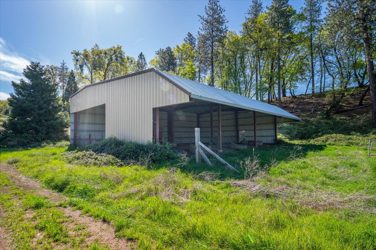 16483 Buzzard Roost Road Bella Vista, CA 96008 - Photo 6 of 138 a backyard of a house with plants and large tree
