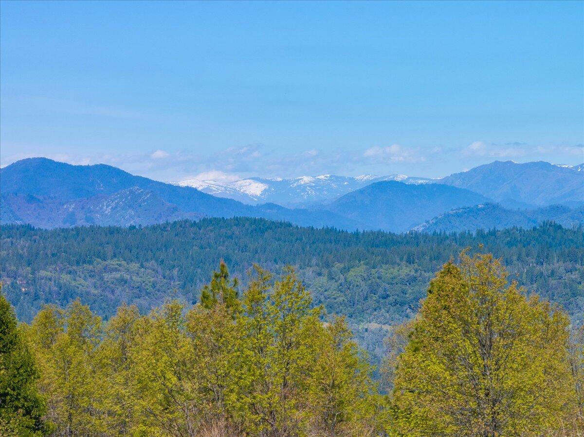 16483 Buzzard Roost Road Bella Vista, CA 96008 - Photo 89 of 138 a view of a lake with mountains in the background