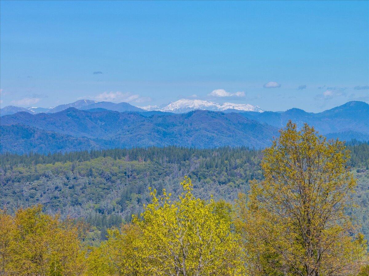 16483 Buzzard Roost Road Bella Vista, CA 96008 - Photo 90 of 138 a view of a lake with mountains in the background