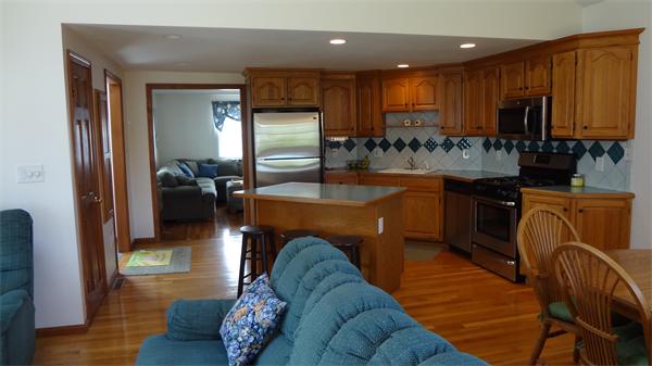 16 Brae Road Weymouth, MA 02191 - Photo 3 of 22 a kitchen with stainless steel appliances granite countertop sink microwave and wooden floor
