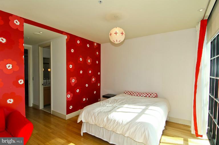3303 Water Street Northwest, Unit 7AN Washington, DC 20007 - Photo 2 of 30 a bedroom with a bed and a lamp on dresser