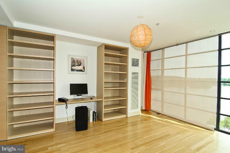 3303 Water Street Northwest, Unit 7AN Washington, DC 20007 - Photo 12 of 30 a view of a livingroom with wooden floor and a window