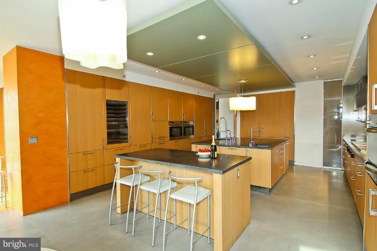 3303 Water Street Northwest, Unit 7AN Washington, DC 20007 - Photo 13 of 30 a kitchen with a sink and chairs