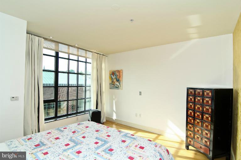 3303 Water Street Northwest, Unit 7AN Washington, DC 20007 - Photo 17 of 30 a bedroom with a bed and a window