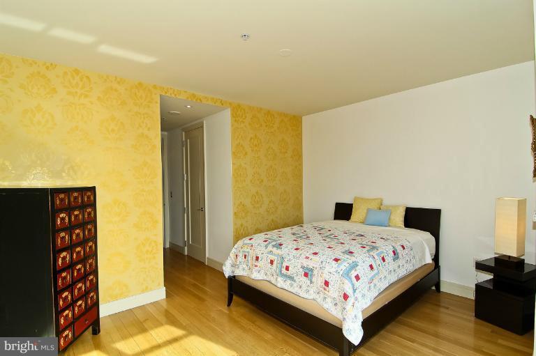 3303 Water Street Northwest, Unit 7AN Washington, DC 20007 - Photo 21 of 30 a bedroom with a bed and a painting on the wall