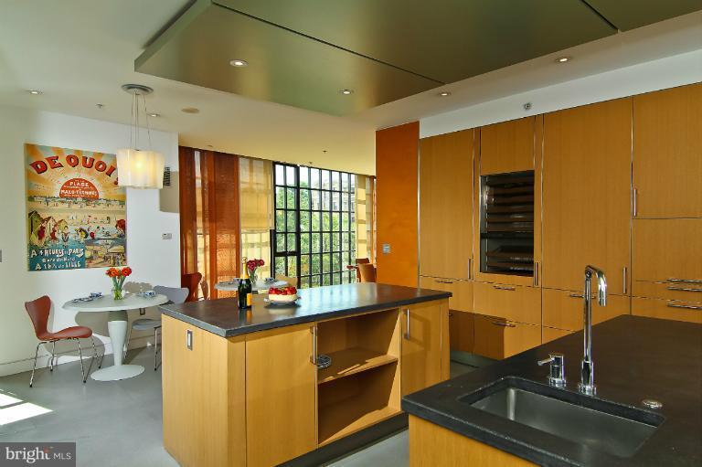 3303 Water Street Northwest, Unit 7AN Washington, DC 20007 - Photo 8 of 30 a kitchen with a sink stove and cabinets