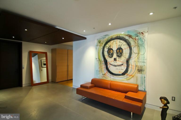 3303 Water Street Northwest, Unit 7AN Washington, DC 20007 - Photo 9 of 30 a hall with furniture and a mirror