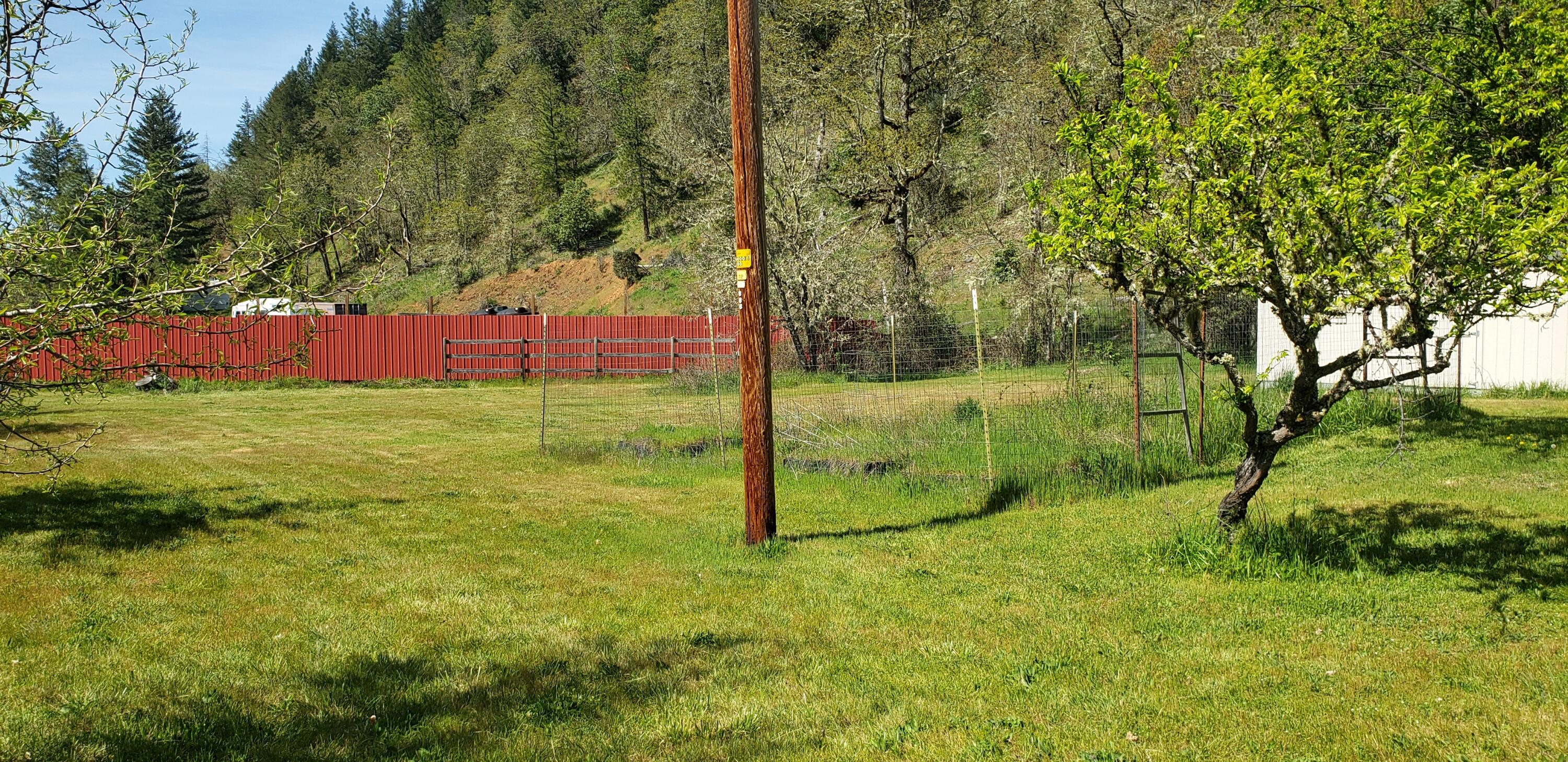 7055 Takilma Road Cave Junction, OR 97523 - Photo 24 of 26 Red fence beyond pasture is neighbors pr