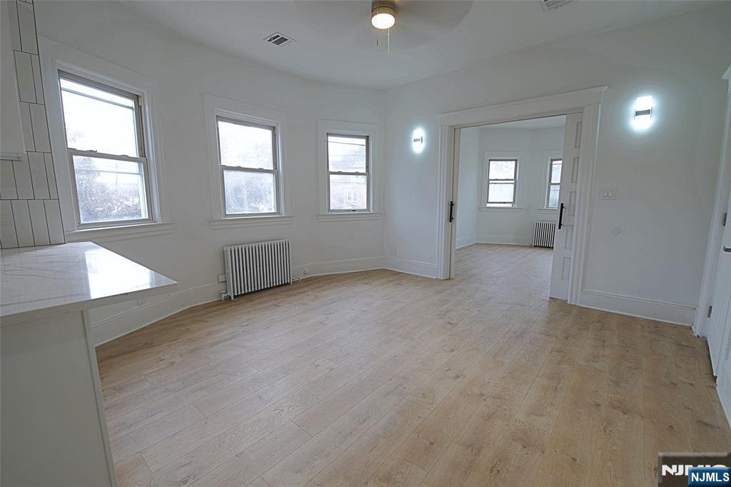 63 Van Winkle Avenue, Unit 2 Garfield, NJ 07026 - Photo 12 of 15 an empty room with windows and cabinet